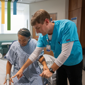 Male OT works with patient using a walker.