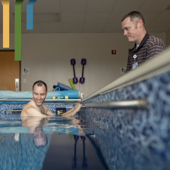 Male OT works with a patient in a pool at Duke Health Lake Norman Hospital.