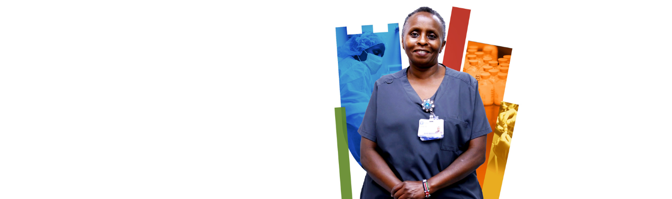 Pharmacy team member smiles with colorful Duke shield in the background.