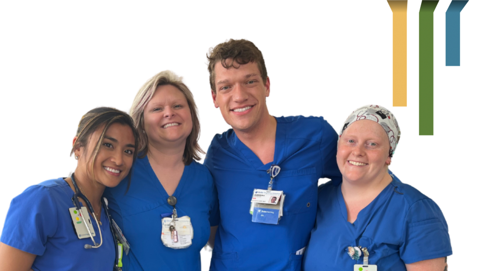 Four male and female team members smile in blue scrubs together.