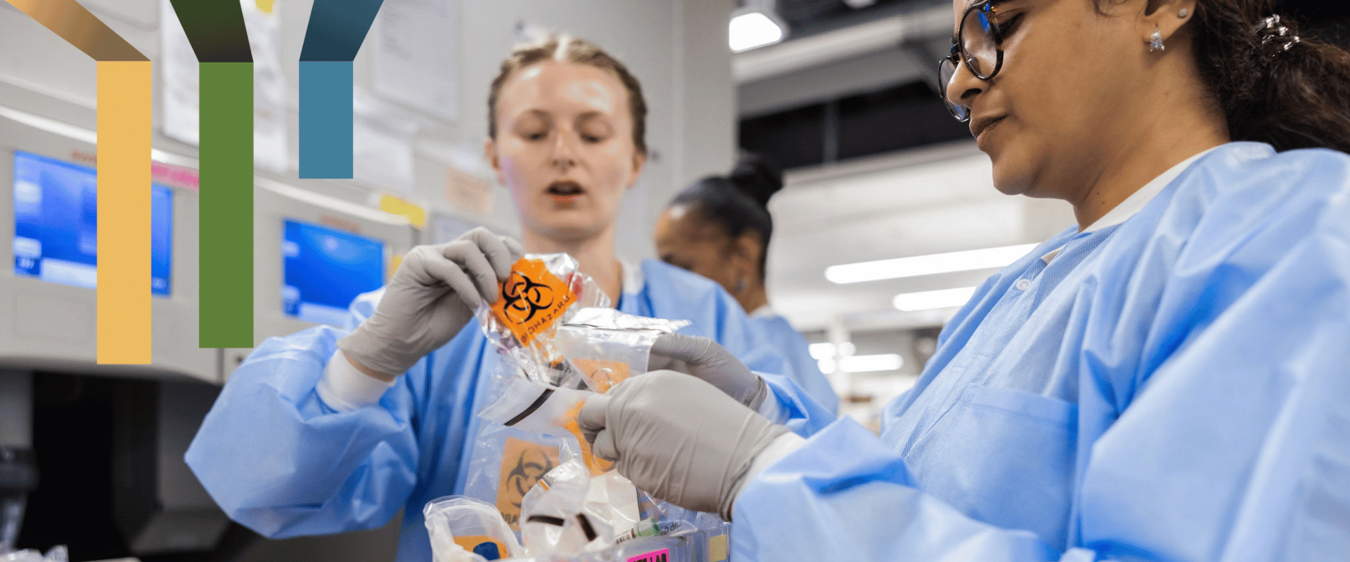 Two lab team members package specimens in bags.