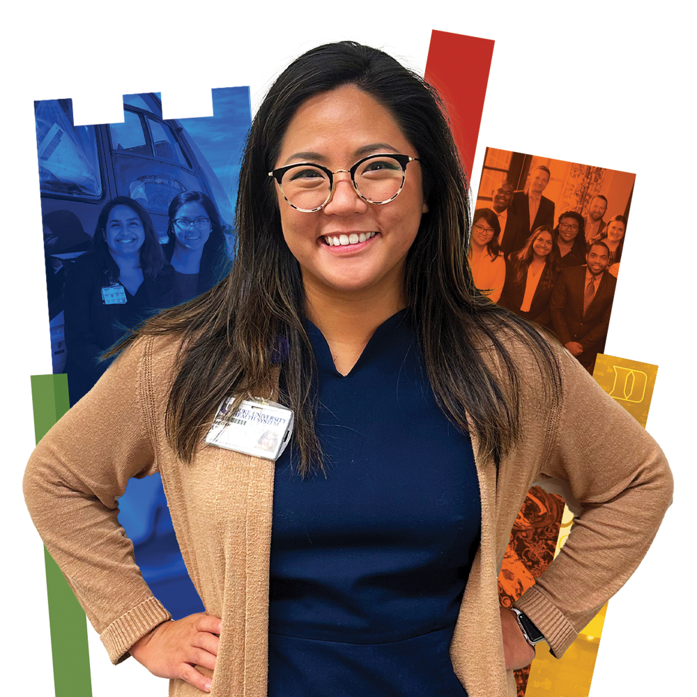 Women smiling in a sweater with a colorful Duke shield in the background.