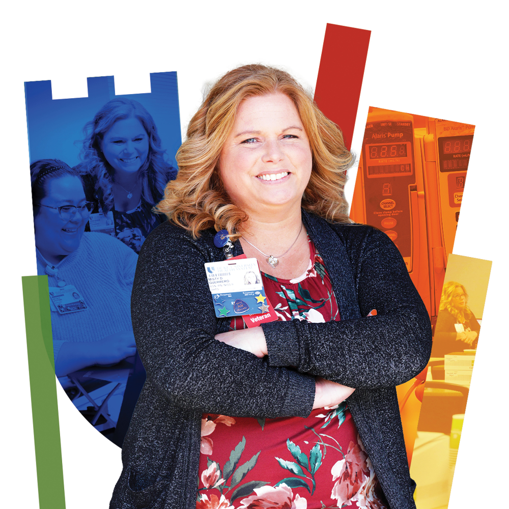 Femal team member in business casual clothes in front of a colorful Duke shield.