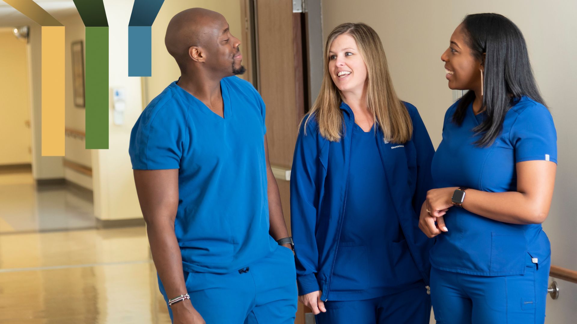 Three nurses talk together at Duke Raleigh Hospital, a campus of Duke University Hospital.