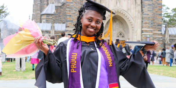 Vida smiles in a graduation cap and gown.