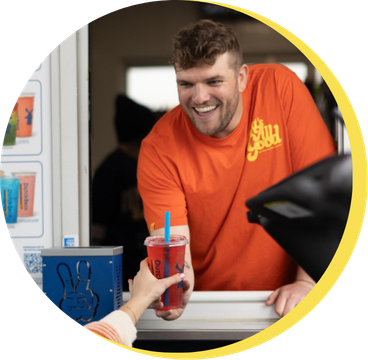 Man giving drink out the window 