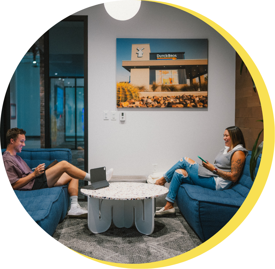 Two people at HQ sitting on couches talking