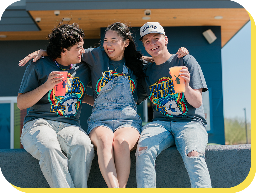 Broistas smiling at a Drink one for Dane event