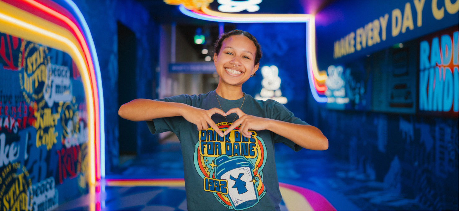 Employee doing the heart symbol in our HQ game day tunnel
