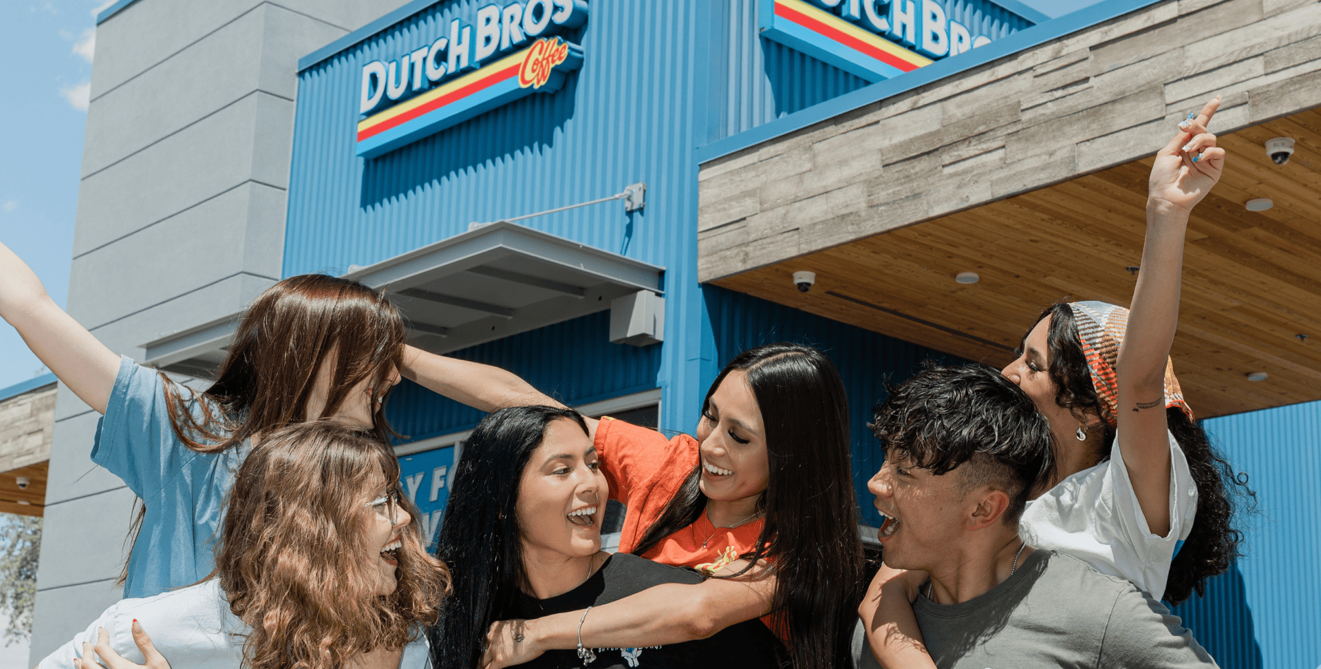 Brositas cheering in front of a Shop