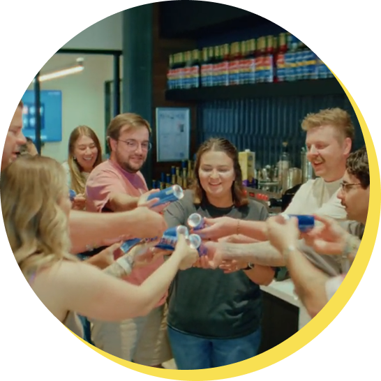 Employees raising a toast with Dutch Bros drinks