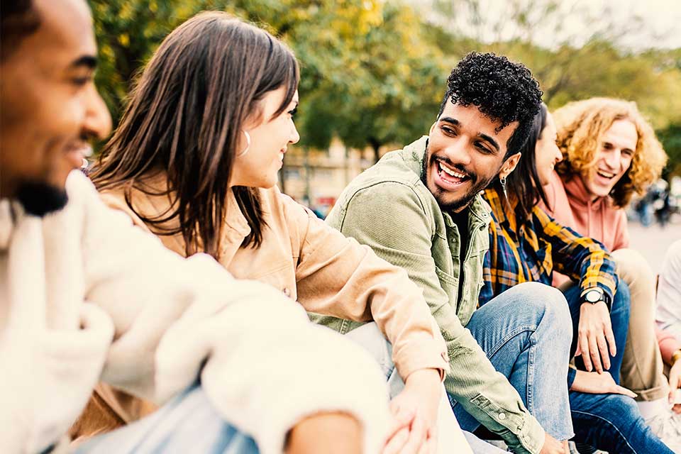 People sitting on bench laughing