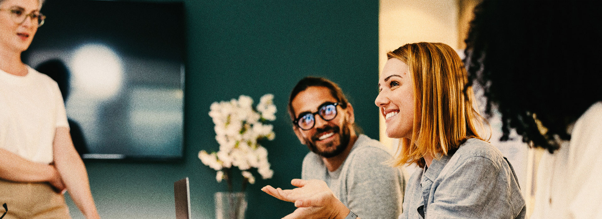 Person talking in workplace happily.