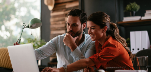A man and a woman collaborate in a modern office.