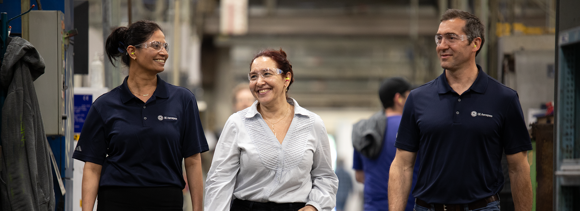 Two women and man walking together