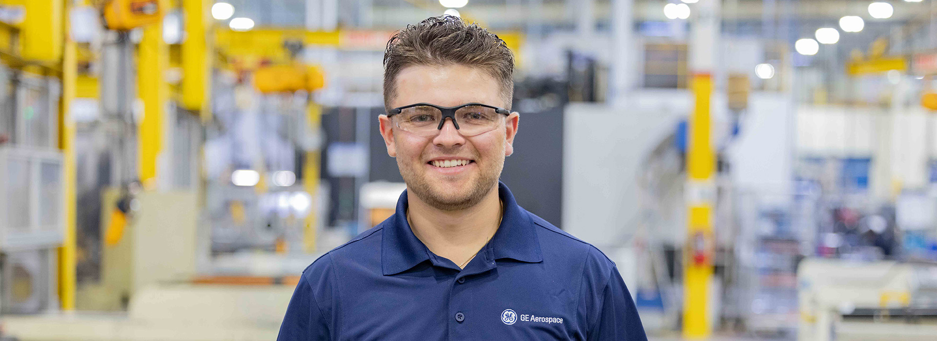 Young man standing in factory