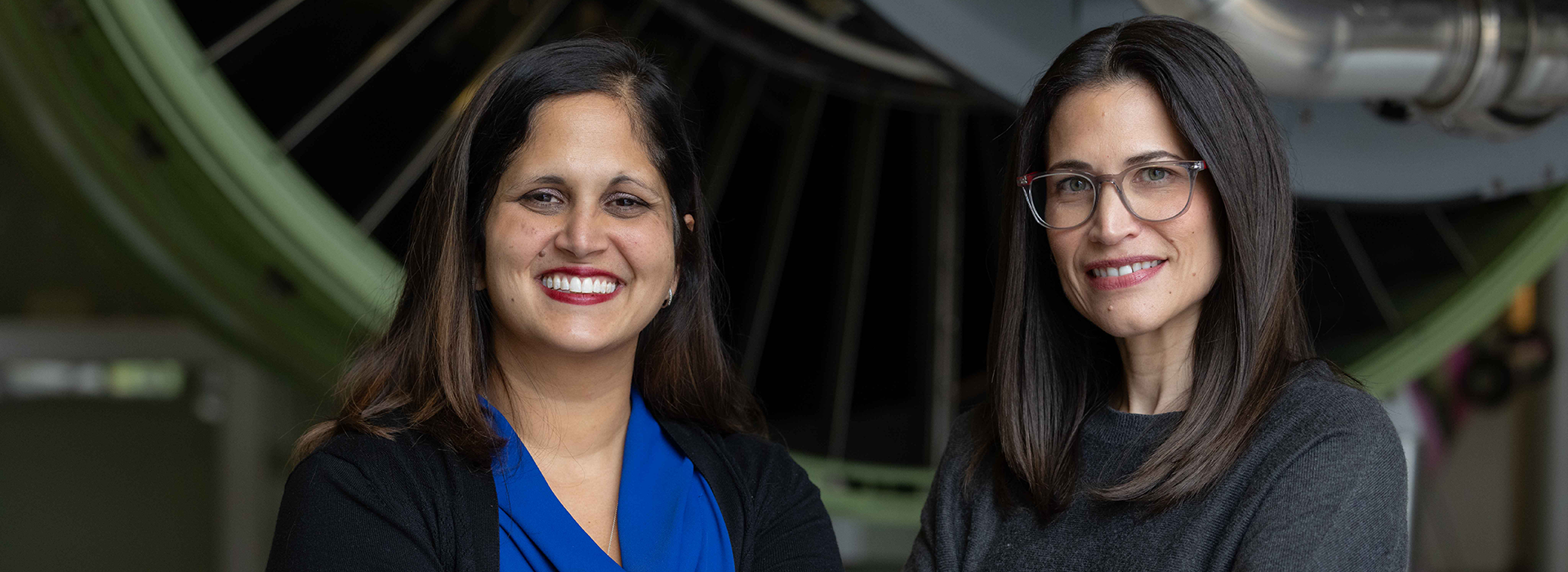 Two professional woman looking at the camera.