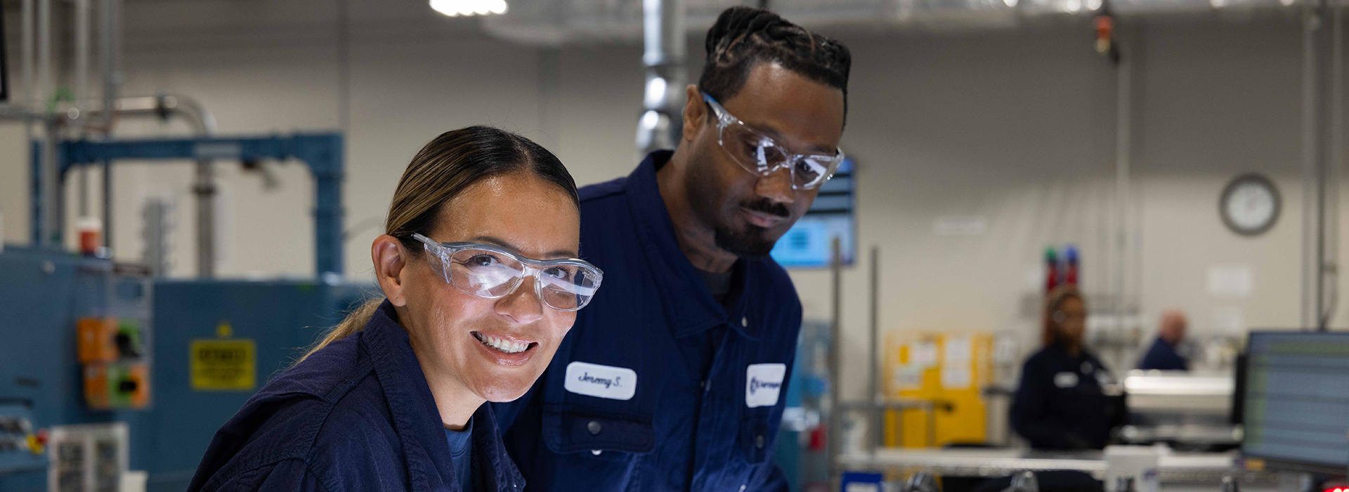 Woman and man in manufacturing site