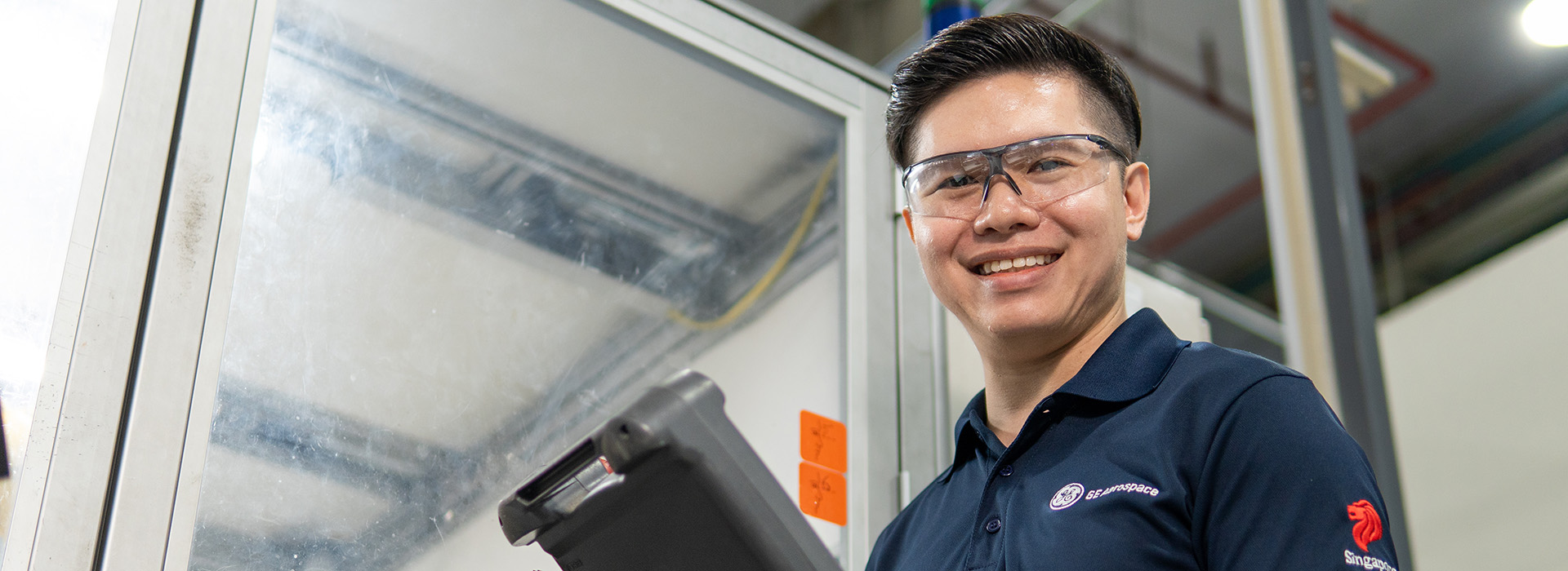 Young man smiling at camera in workplace