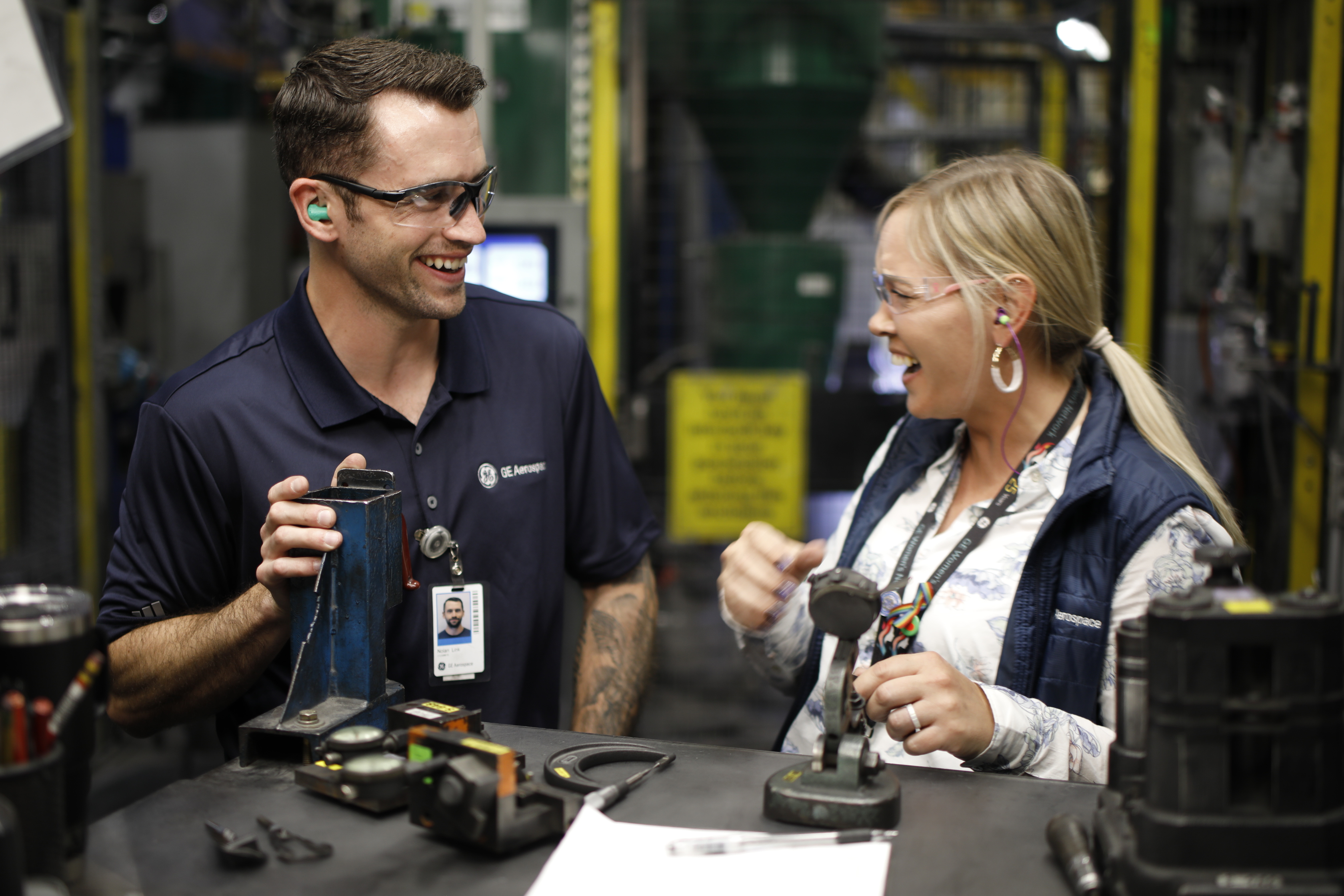 Two employees talking in manufacturing environment