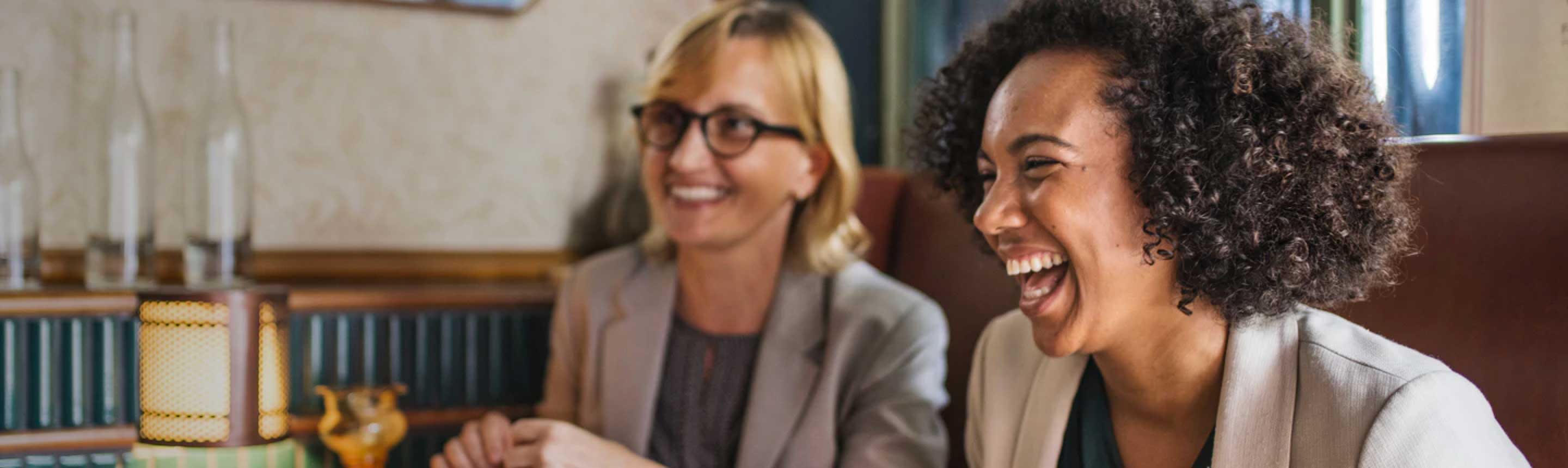Two women employees laughing