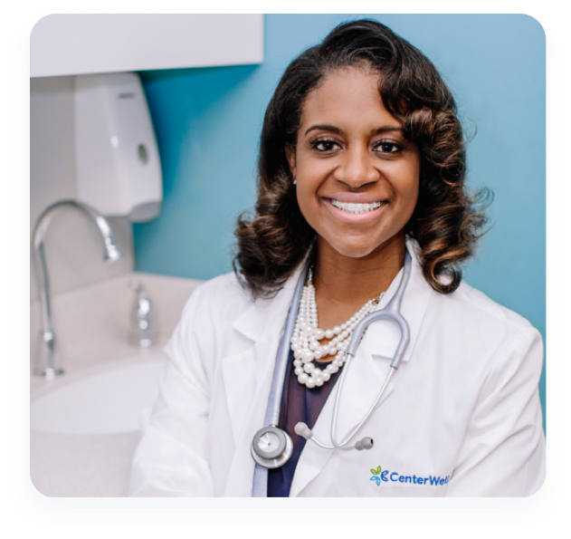 A smiling female CenterWell senior primary care center doctor.