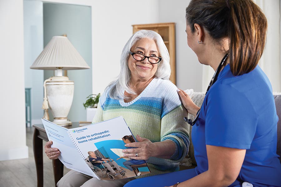 CenterWell Home Health female nurse speaking with elderly woman in a home setting