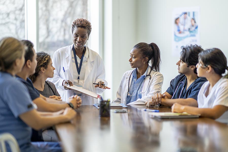 Female physician speaking to a group of healthcare students