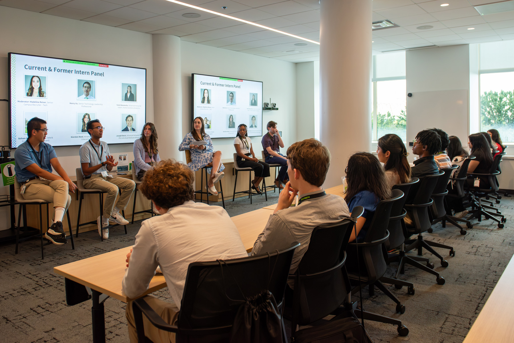 Group of Humana interns interacting with a panel of speakers in large conference room