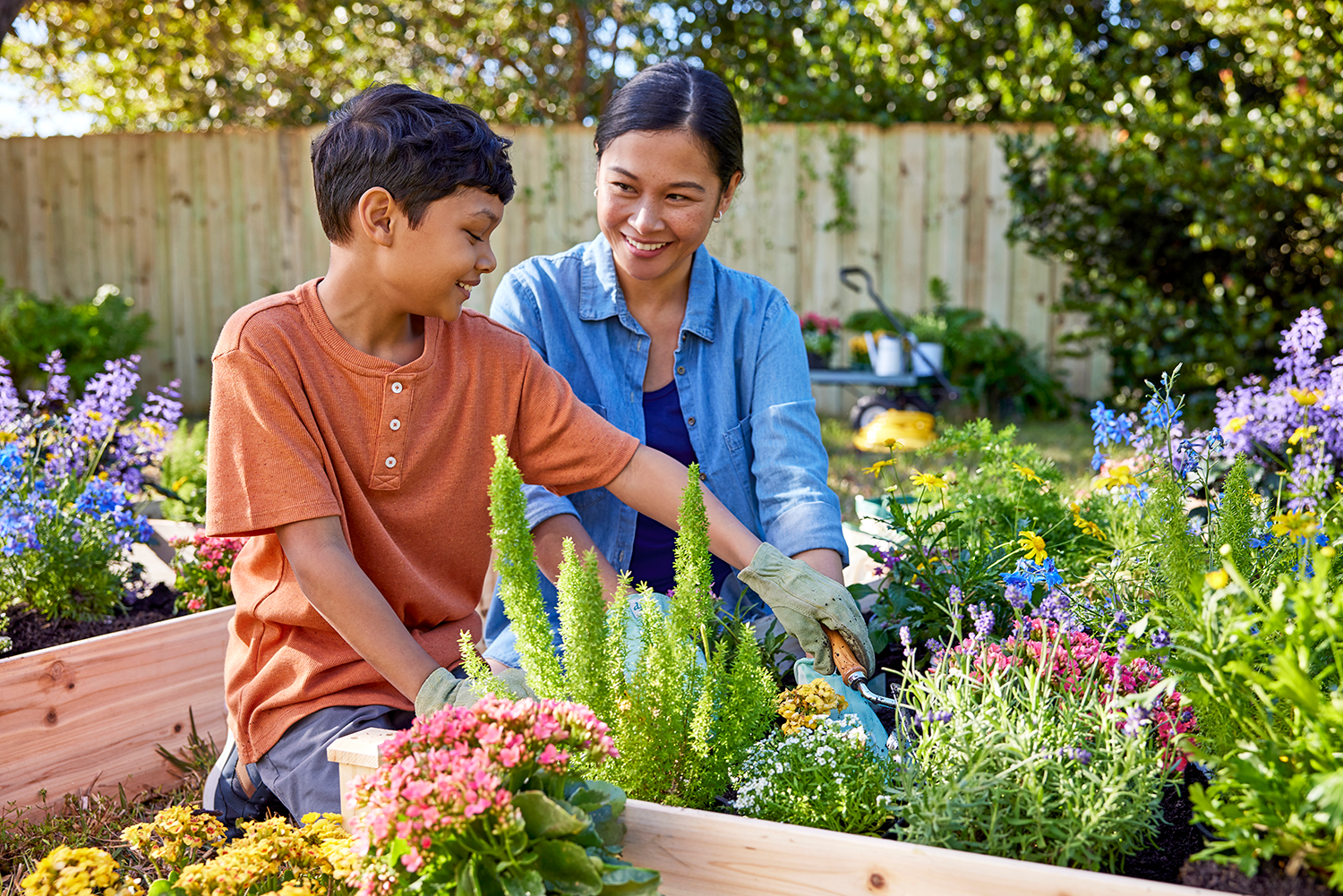 A woman and her son garden together