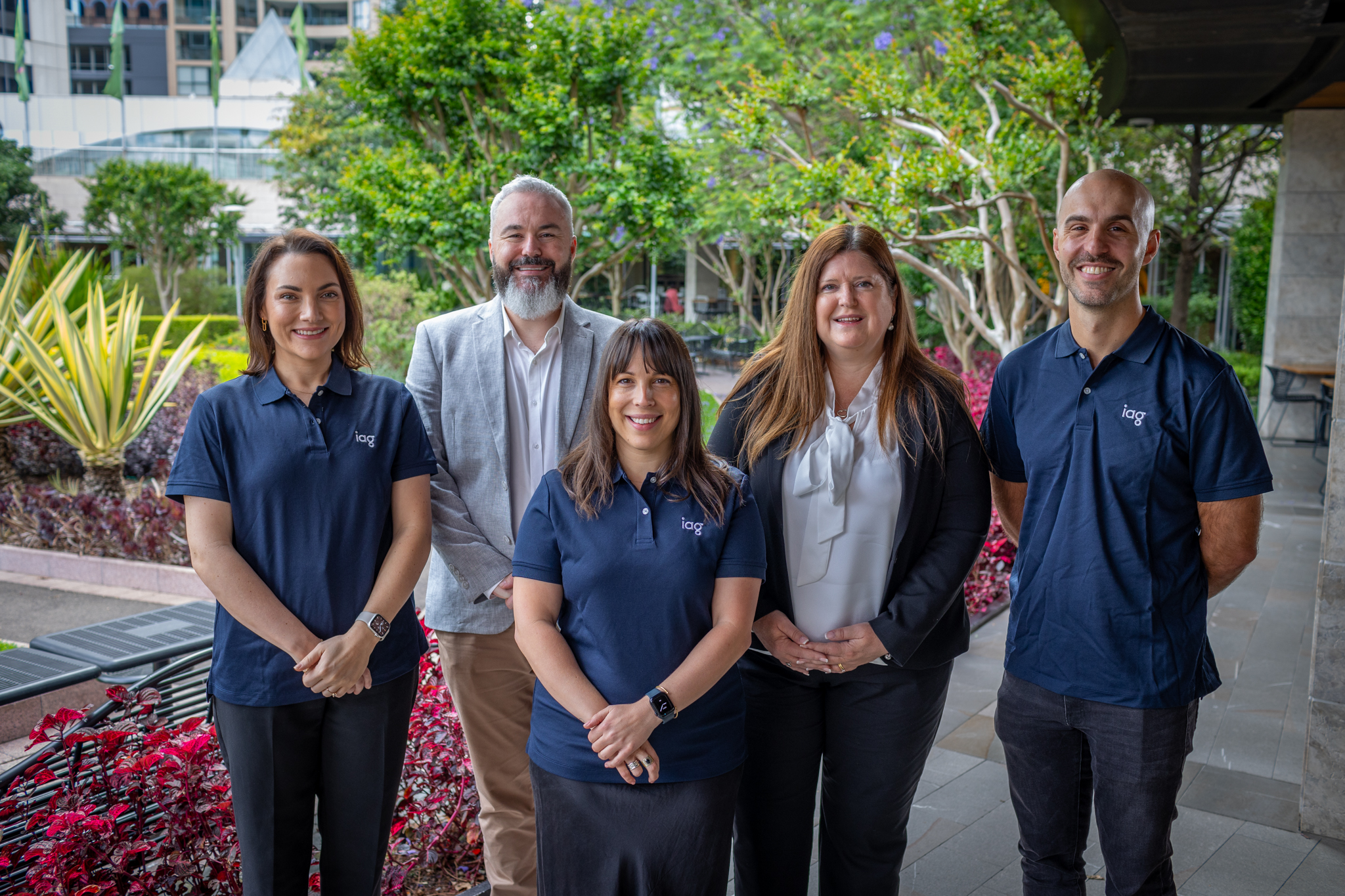 Five diverse IAG employees in Sydney office garden