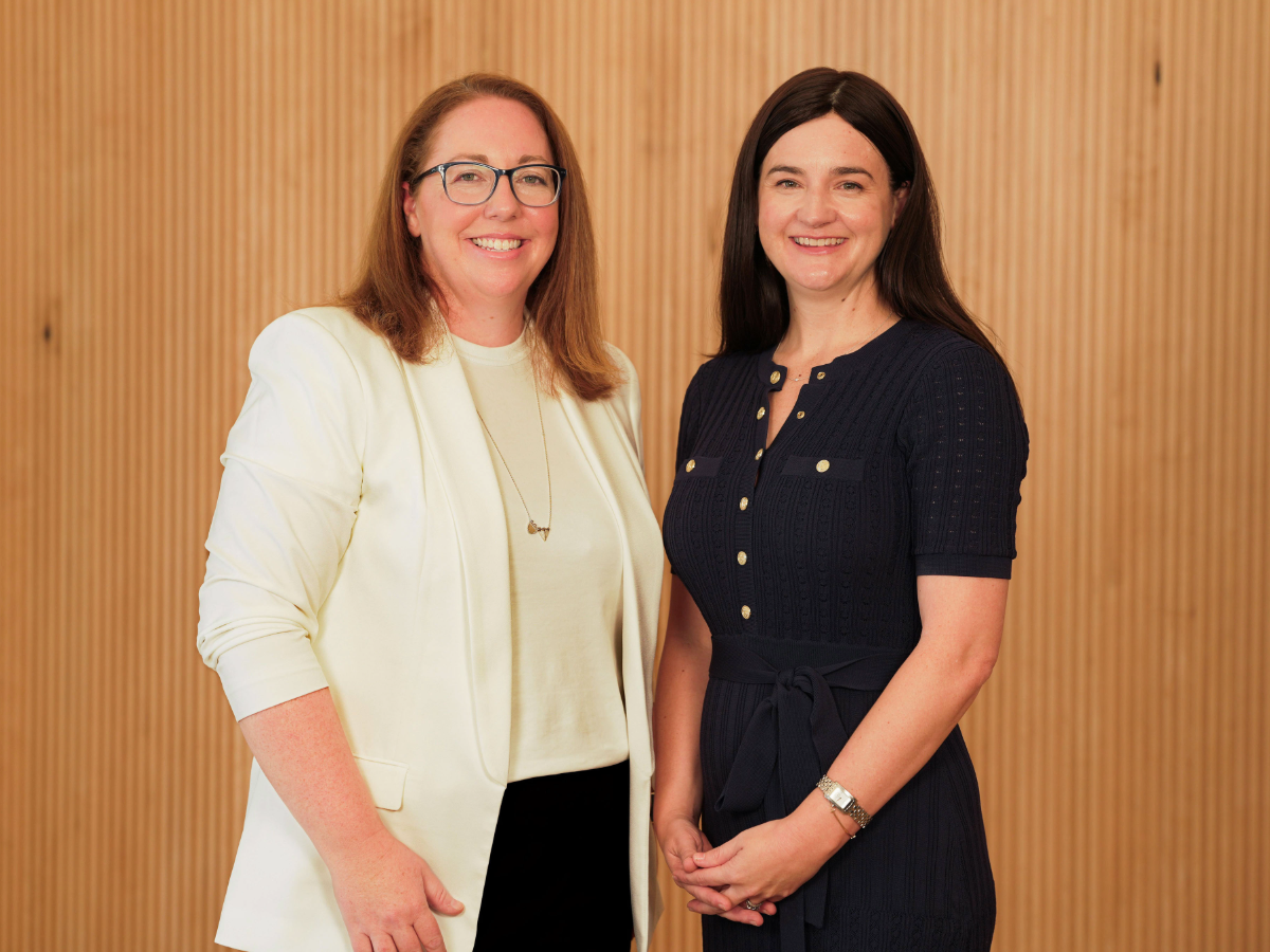 2 customer advocate leaders smiling at camera