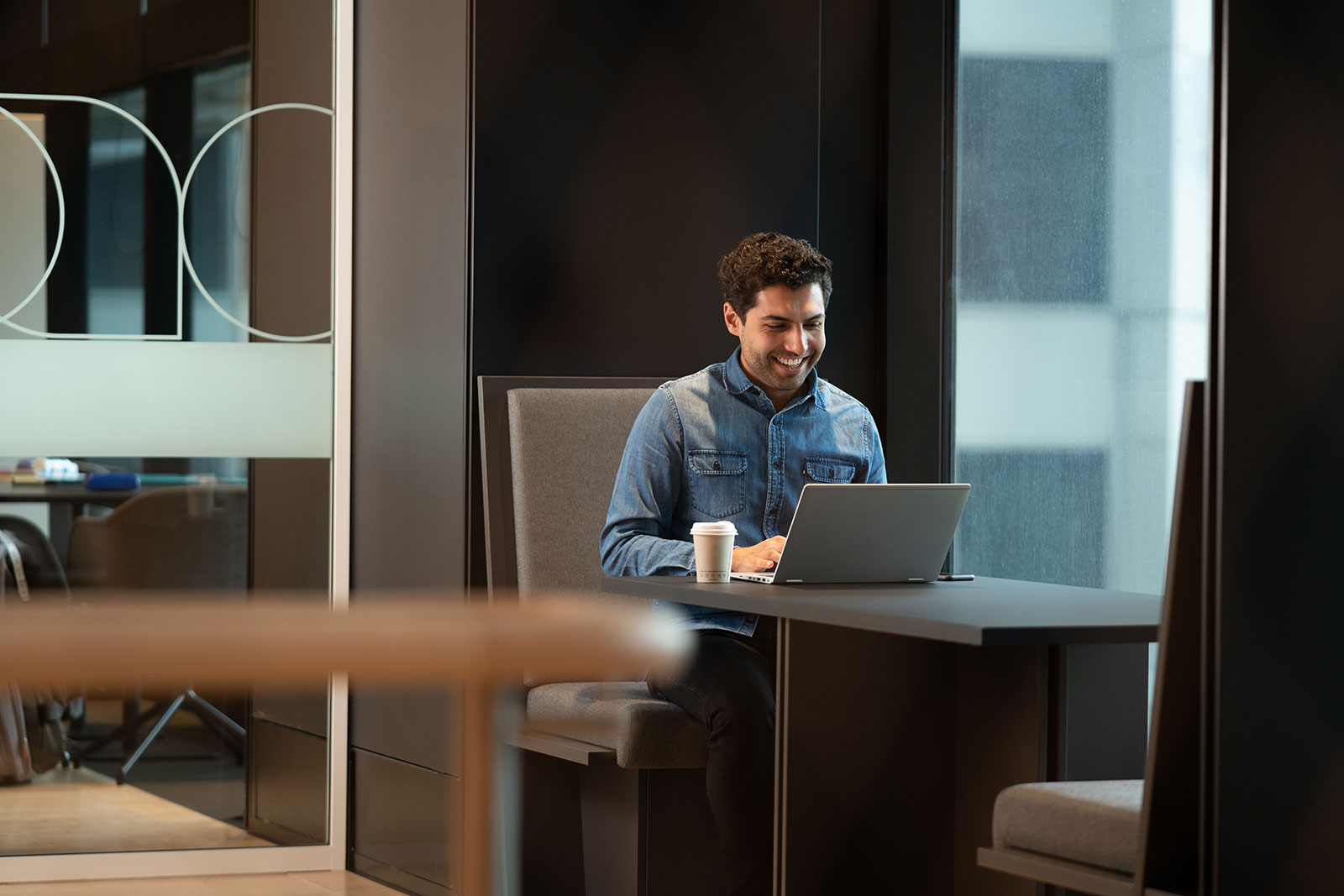 Male typing on laptop computer in office