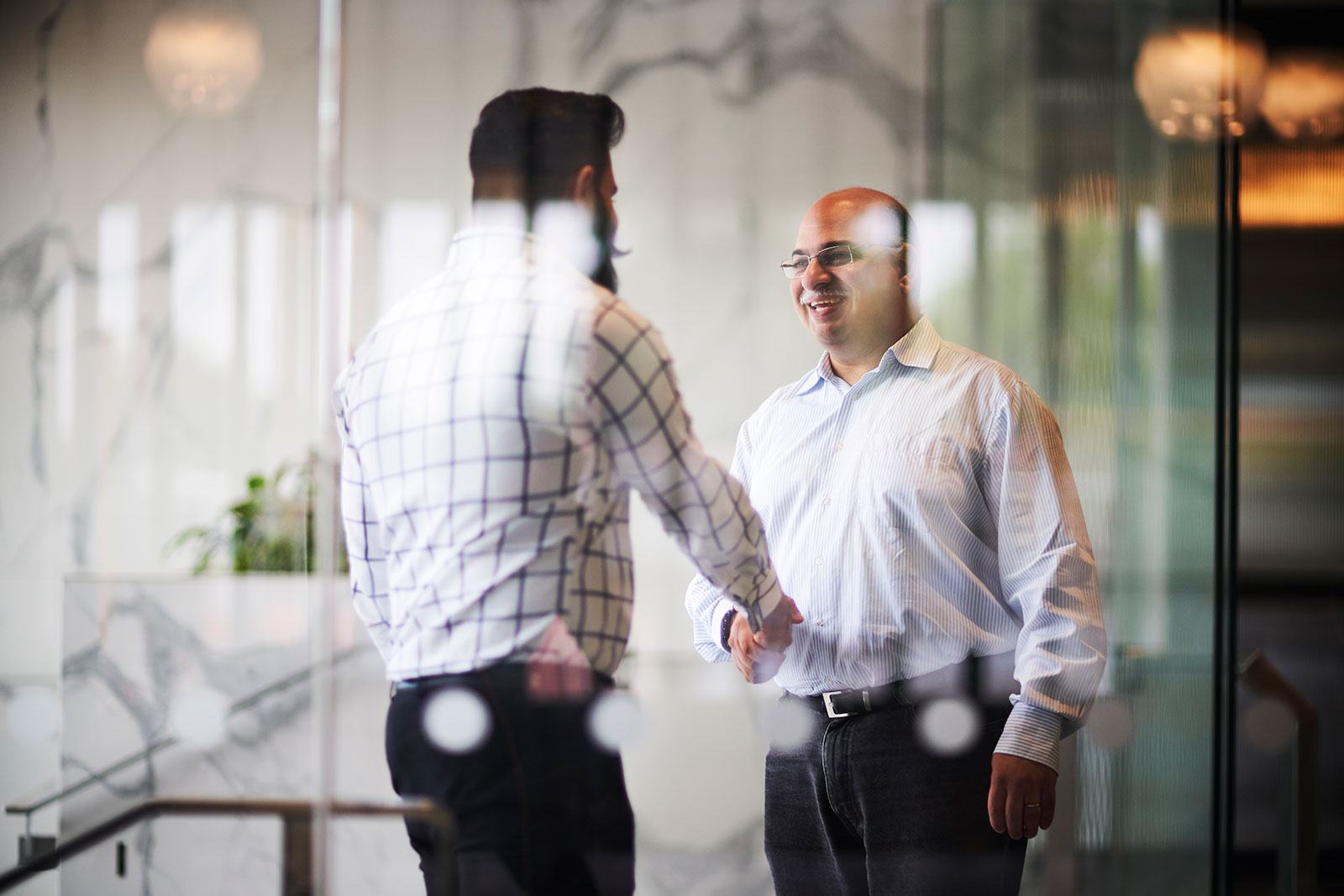 Two IAG employees shaking hands