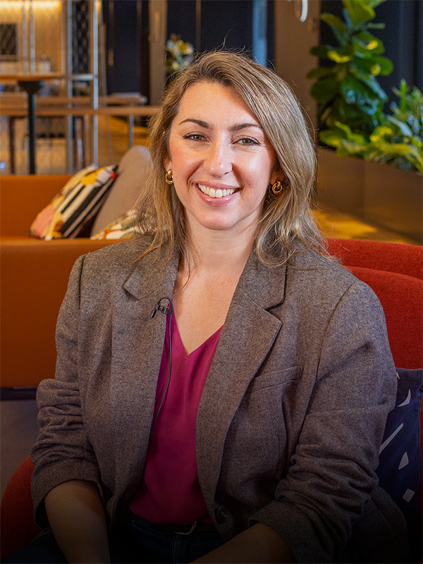 IAG technology & data staff member, smiling at camera