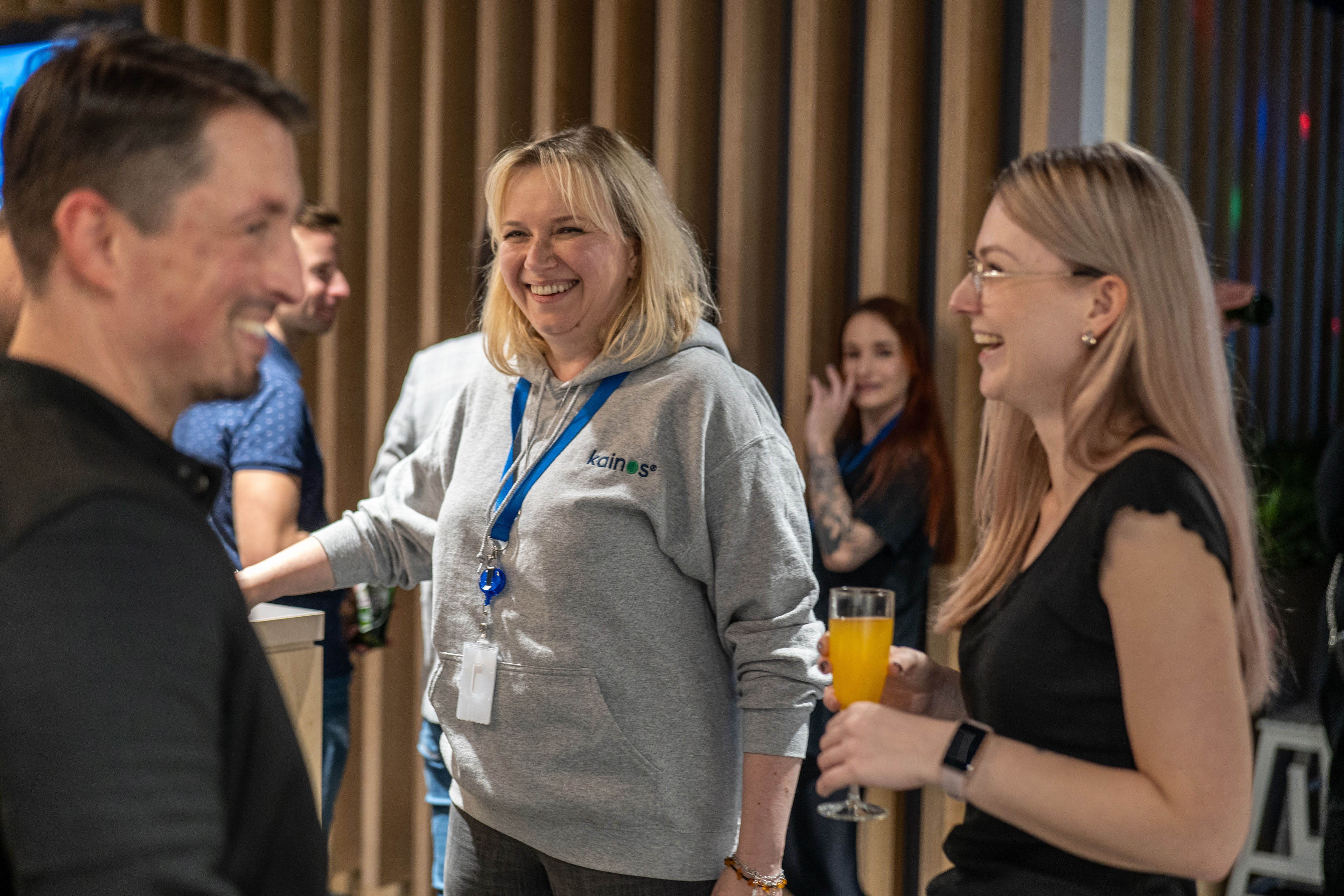 Three colleagues chatting and laughing