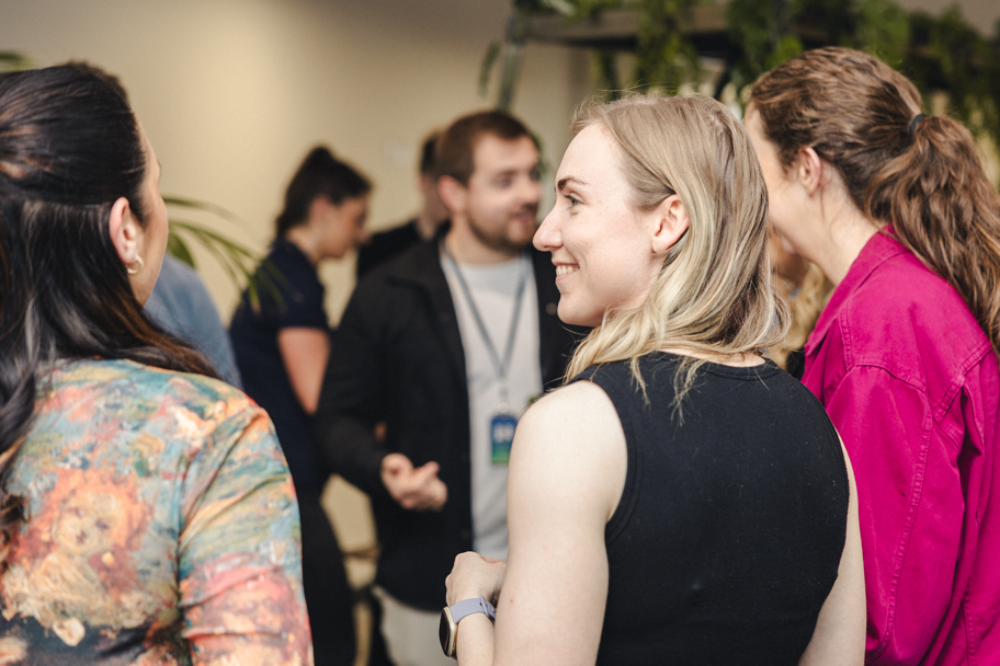 Group of people socialising in an office setting 