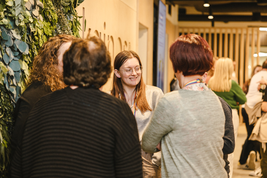 Group of people talking in an open plan office