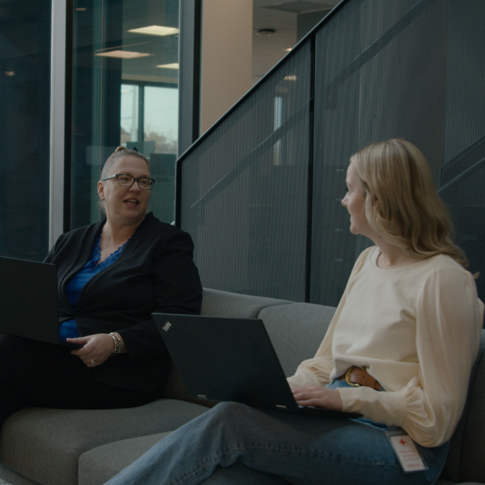 Photo of two women talking at HQ