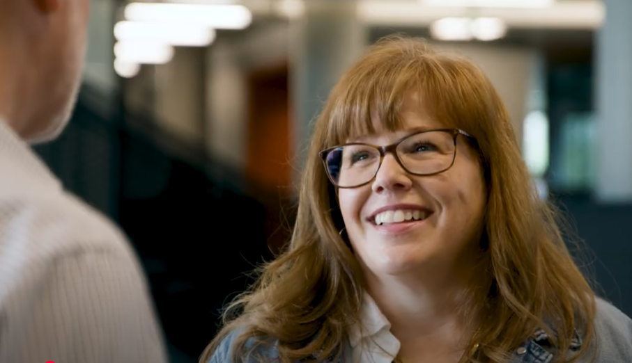 Woman talking to a coworker at our HQ 