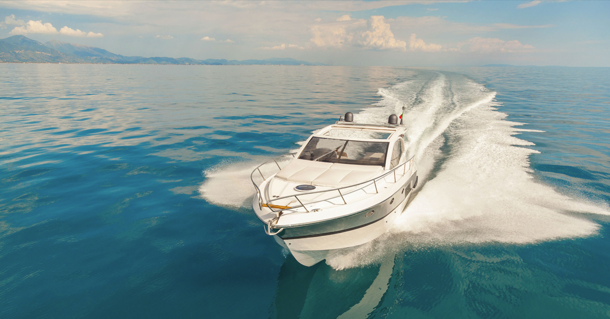 Picture of a boat in open water with an island in the background
