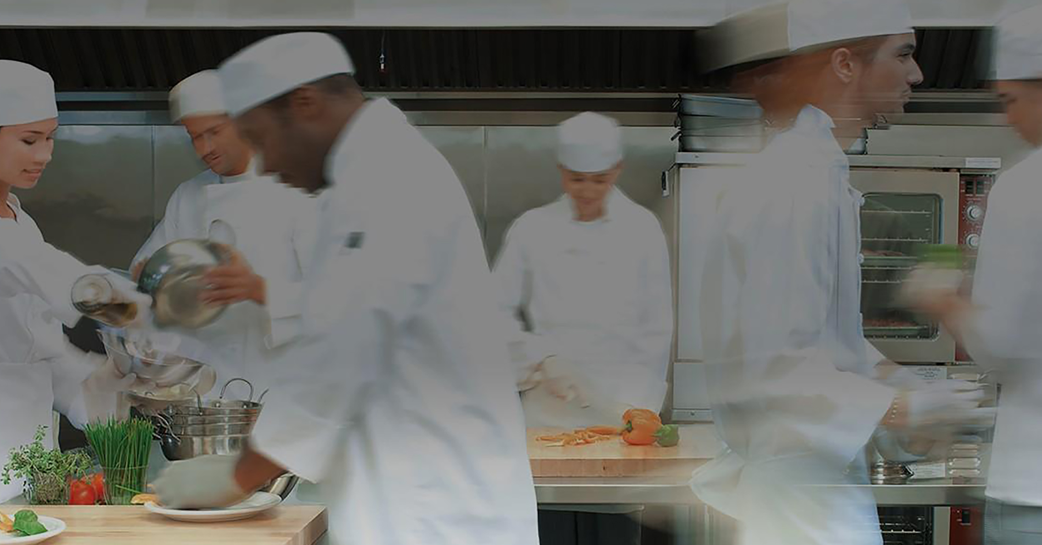 Chefs preparing food in a kitchen