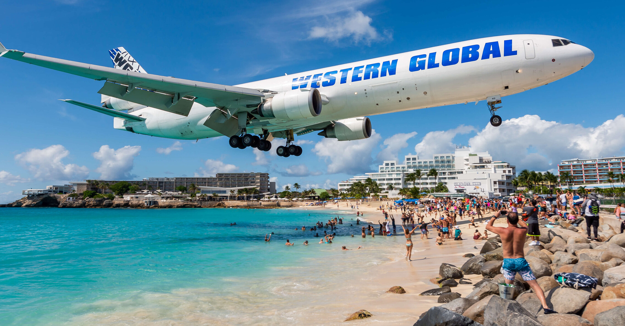 Western Global Jet flies over a beach