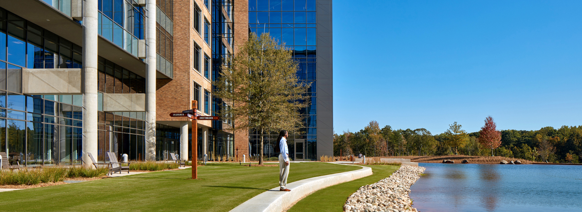 Diverse man standing by the Fort Mill Office lake