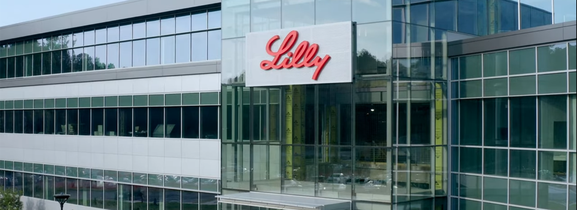 Photo of Lilly logo on building with multiple windows