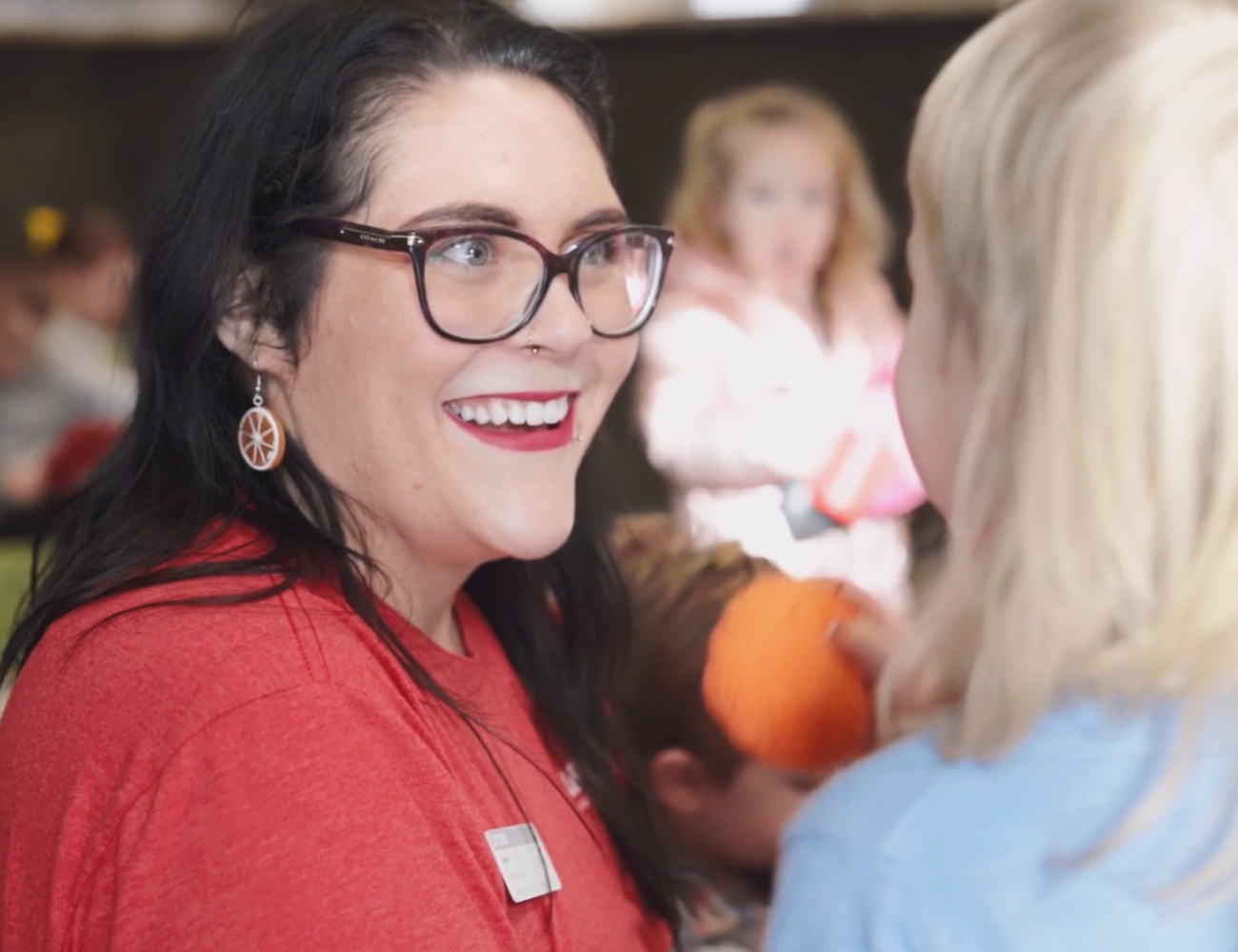 Life Time kids activities team member postively interacting with a parent at Life Time.