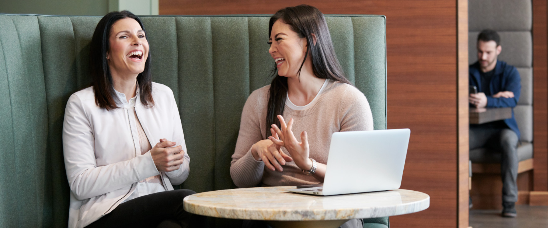 Two corporate female Life Time employees engaging in conversation about Human Resources at Life Time corporate.