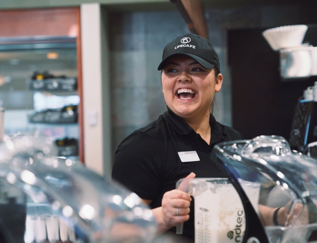 Life Time Life Cafe team member and supervisor making a protein shake at Life Cafe.