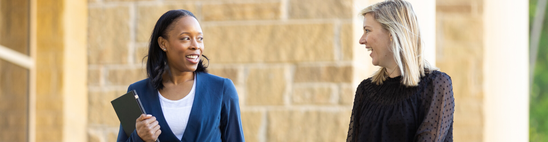 Female associates walking outside at corporate headquarters