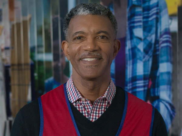 Corporate associate standing in front of a mural at corporate headquarters